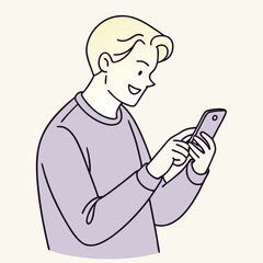 Smiling young man is typing on his mobile phone and looking down