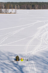 Silhouette of Ice Fisherman. Vertical Winter Panorama from Frozen Lake