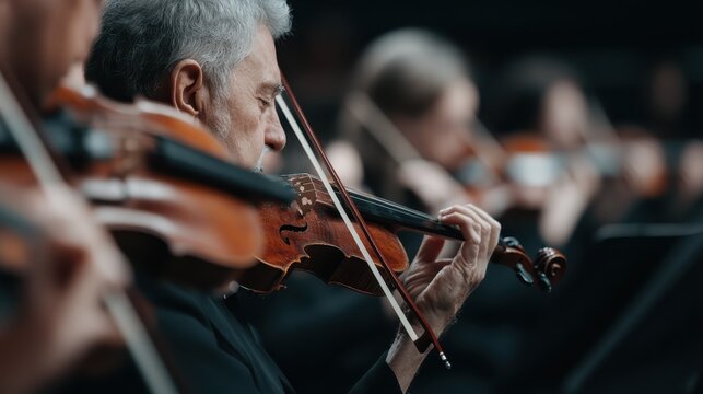 An experienced violinist plays passionately, captured in a moment of intense focus during a performance, embodying dedication and artistry in musical expression.