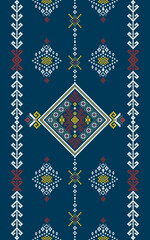Traditional geometric embroidery pattern with diamond shapes and intricate motifs in red, yellow, and white on a dark blue background.