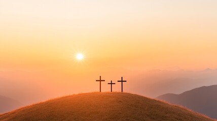 Three wooden crosses on a hilltop at sunrise