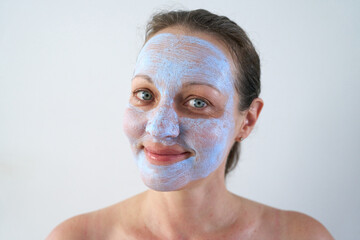 Portrait of woman with healing mask on her face.