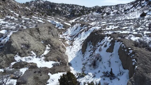 Rough desert Montana landscape in patchy snow 