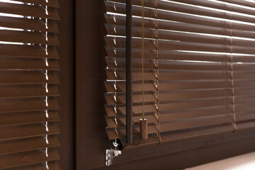 Close-up of wooden blinds made from natural materials, shown partially tilted. These blinds stay cool in the sun, offering light control, privacy, and a stylish, eco-friendly interior solution.