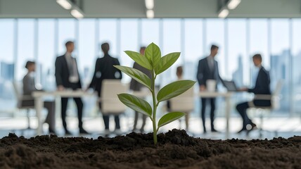 A plant symbolizes growth in a business meeting on green projects.