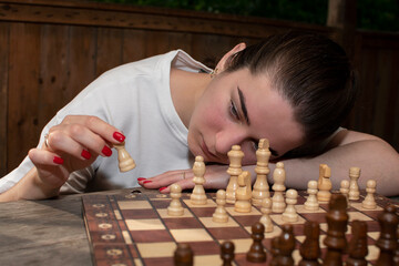 Portrait of a young woman playing chess
