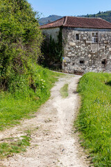 Dirty road with medieval farm houses