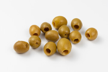 Pickled green olives on a white background. Marinated olives in close-up.