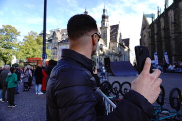 Man watches a street event in the city center