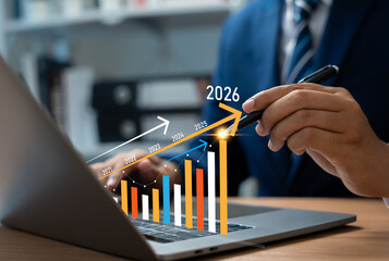 New Year 2026, Businessman using laptop to create new business plan for 2026. Strategy include setting goal,Development organizational direction,Objective,Target new opportunities for future growth.
