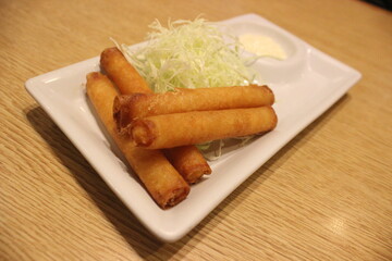 Fried spring rolls and shredded cabbage are a popular snack in many countries.