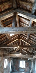 Rustic wooden beams create a charming atmosphere in an unfinished interior space in rural area