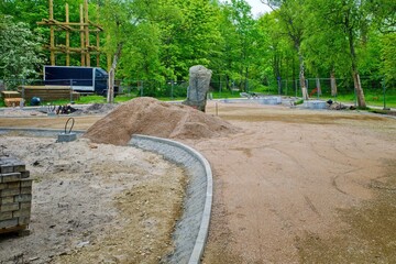 Park Path Under Construction with Gravel and Curbs. Urban Landscape Improvement Project in Green...