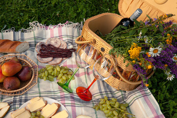 Charming Picnic Scene with Wildflowers, Wine, and Fresh Snacks