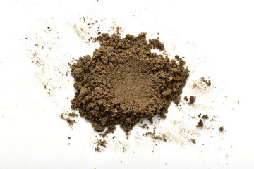 A small pile of soil from the garden lies on a white background.