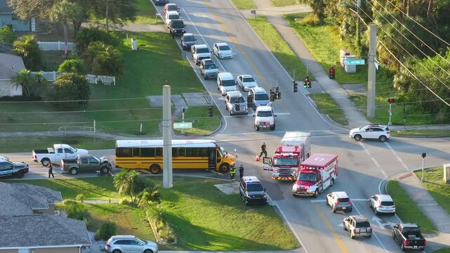 Damaged truck and school bus in traffic accident on American road.