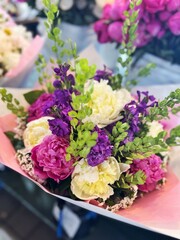 Colorful Bouquet of Fresh Flowers with Peonies and Greenery in Pink Wrapping