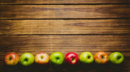 Red and green apples on table