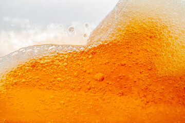 Close up bright orange Oil or beer splash texture and nature waves, Beautiful waves curve and...