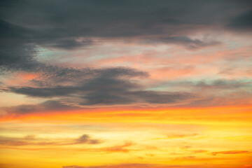 Sky,Beautiful sunset view, luxury soft gradient orange gold clouds and sunlight on the blue dramatic sky perfect for the background, morning, evening,Twilight, climate change,horizontal sunset photo