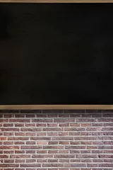 Flat design is showing blank blackboard being mounted on wooden frame above exposed brick wall