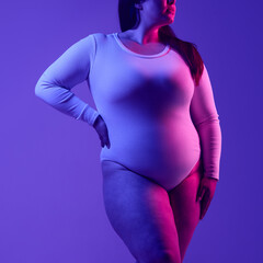 Faceless plus-size woman exuding confidence and empowerment, showcased with bold visual contrast in...