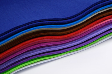 Colorful multi-colored felt on a white background. Soft fabric samples. Wave. Close-up. For design...