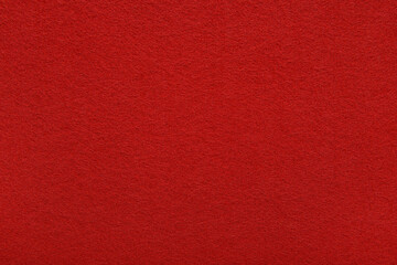Red felt texture background - close-up of soft fabric surface. Seamless background, graphic design, scrapbooking, textile layouts, creative projects.