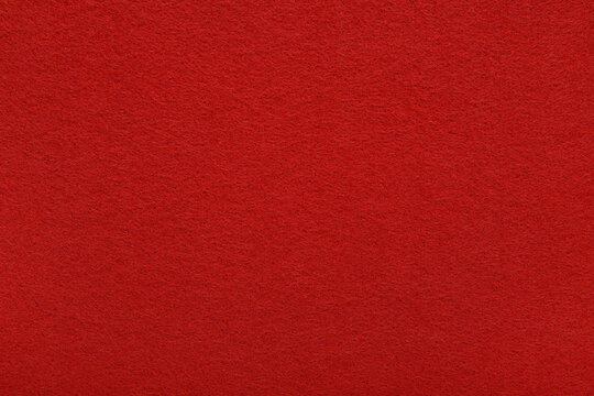 Red felt texture background - close-up of soft fabric surface. Seamless background, graphic design, scrapbooking, textile layouts, creative projects.