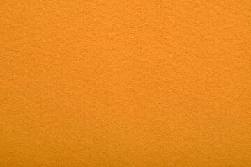 Orange felt texture background - close-up of soft fabric surface. Seamless background, graphic...