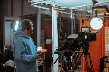 Director of photography with a camera in his hands on the set. Professional videographer at work on...
