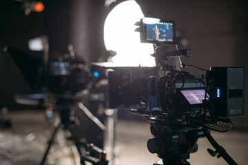 Professional film and video cameras on the set. Filming crew, lighting equipment, professional...