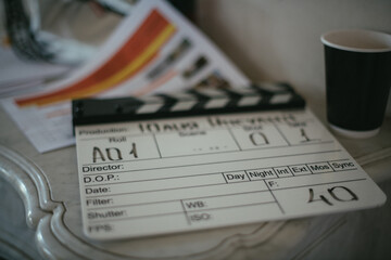 Assistant director with clapperboard on set. Close-up of firecrackers for filming a movie, advertising, TV series. Modern photography technique.