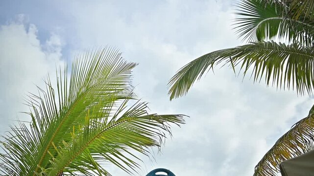 Big surfboard decorative on a Turquoise beach waves gently washing over a white sand beach in the Caribbean. Perfect for travel, tourism, wellness, and relaxation themes. Shot in slow motion for a cin