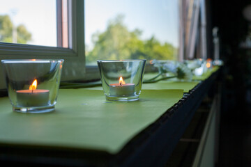Softly glowing candles placed elegantly on a windowsill create a wonderfully serene and beautiful atmosphere