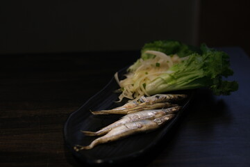 Oven baked fish sardines, with tomatoes, lemon and rosemary. Top view. High quality photo