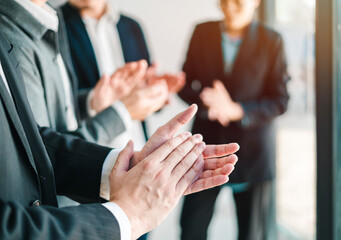 group of businessmen applaud in unity after successful team strategy meeting cooperation harmony and teamwork in productive business environment.