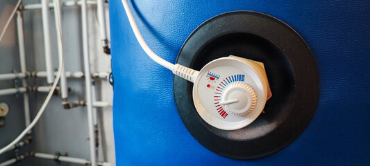 Thermostat control knob on a boiler, gas or hot water boiler. Eco mode concept on a heating system...