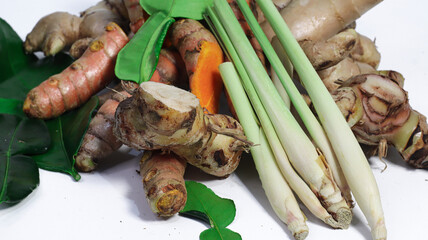 Culinary Freshness: A vibrant arrangement of turmeric, lemongrass, and galangal, meticulously...