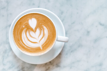 Cup of cappuccino on a table in a cafe, no people, close-up.