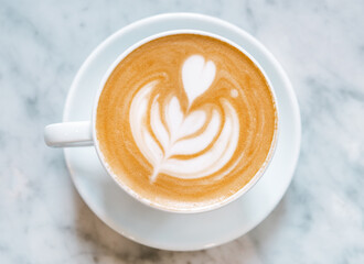Cup of cappuccino on a table in a cafe, no people, close-up.