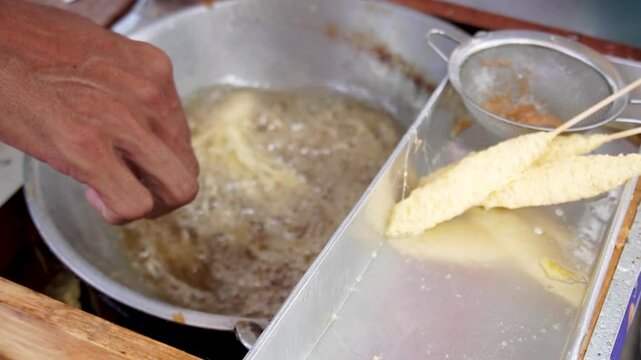 Telur Gulung is street food from indonesia that is made from eggs that mixed with bihun (rice noodles) and rolled with a skewers.
