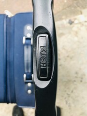 Travel suitcase with push handle for easy mobility in transit