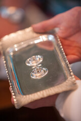 A stunning silver tray beautifully presenting two wedding rings, which symbolize love and lifelong commitment