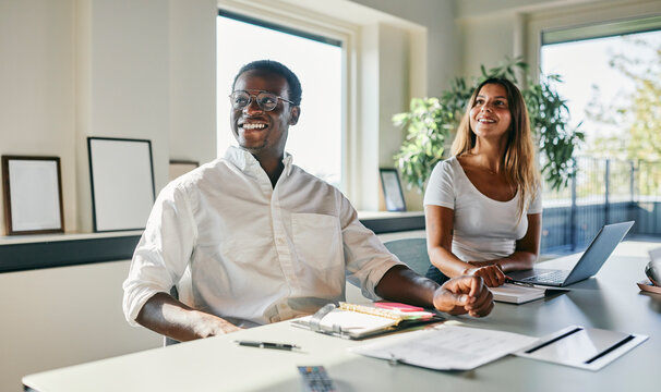 Two diverse Colleagues Collaborating in a Bright Modern Office Environment
