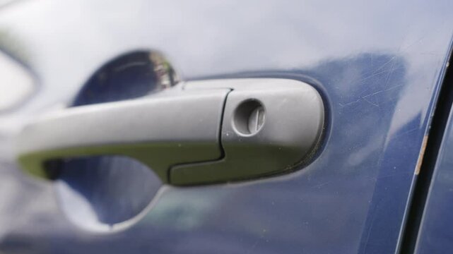 Closing and locking car door close up on handle 4k

