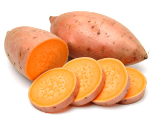 Sliced and whole sweet potatoes showing vibrant orange flesh