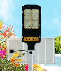 Outdoor solar lights with motion sensor and remote control, installed near the parking lot,...