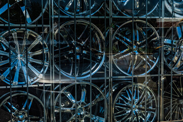 Chrome automobile wheels for sale in a shop