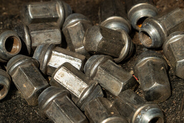 A pile of old wheel lug nuts
